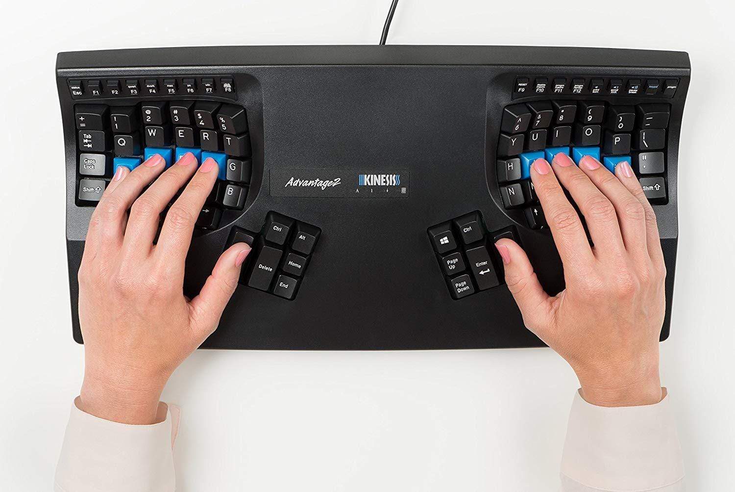 Kinesis Advantage 2 keyboard, with a Caucasian individual's hands resting on the palm rest, and their fingers resting on the home row and thumb clusters respectivley