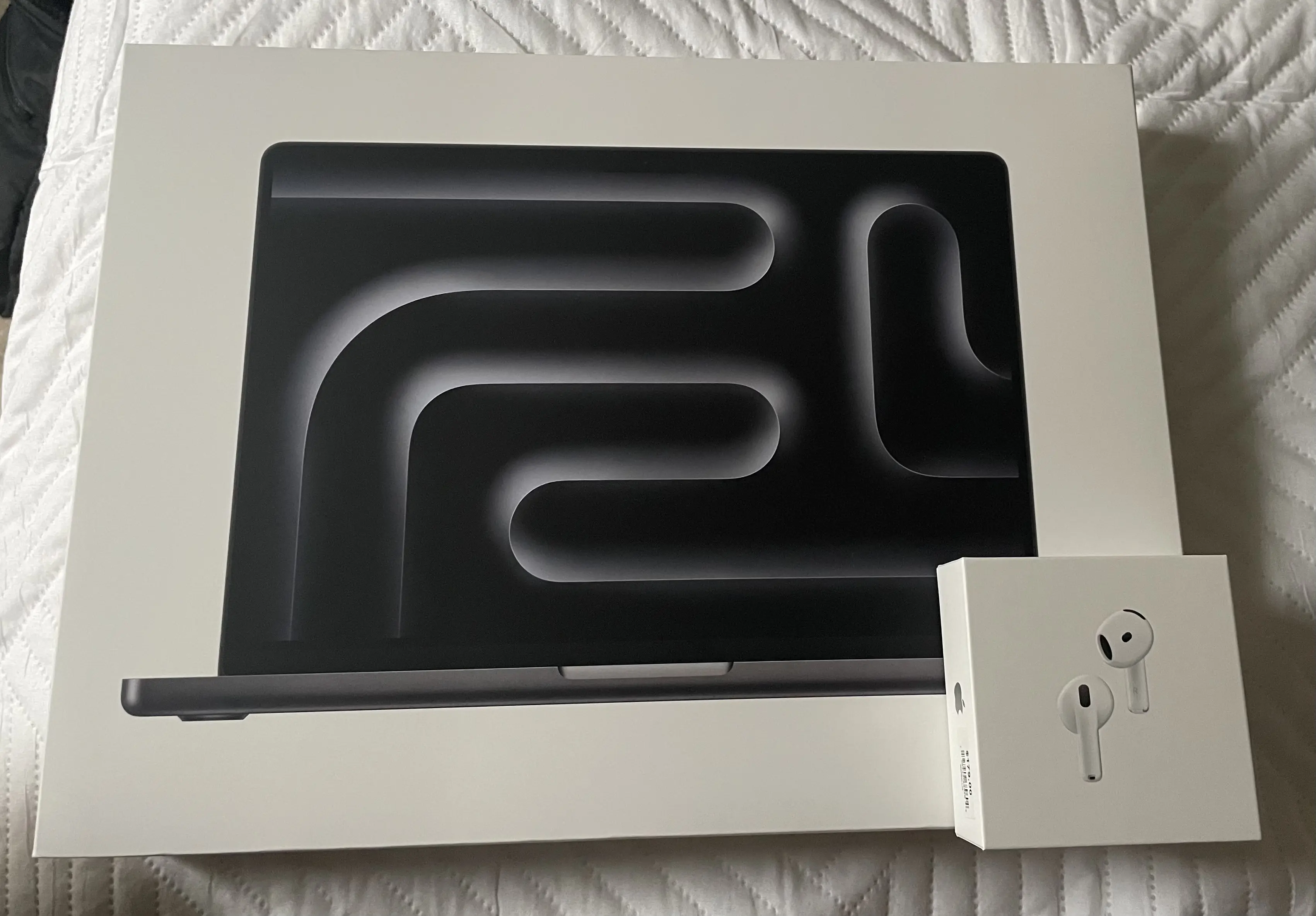The Apple packaging of the 14 inch M4 MacBook Pro and Airpods 4 Active Noise Cancelling